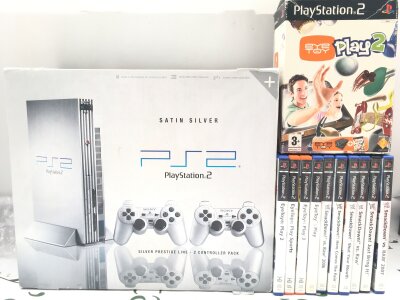 A Boxed Sony PlayStation 2 Satin Silver With A Collection Of Games. No Reserve.