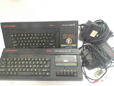 A Box Containing A Sinclair Spectrum +2A And A Spectrum +3 with Some Leads, Joysticks And Software.