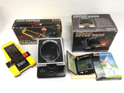 Three boxed vintage electronic games comprising a Grandstand Astro Wars, Galaxy Invader 1000 and Golf Master 2.