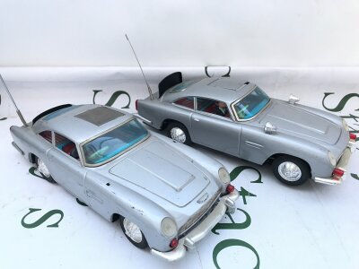 A Gilbert Battery Powered James Bond Aston Martin DB5 (A.f.) And A ASC Battery Powered Aston Martin DB5.