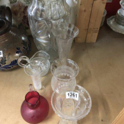 A Collection of glass ware including a large cut glass vase and a cranberry jug .