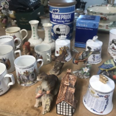 A collection of ceramics including commemorative bells animals figures and Belleek vases .