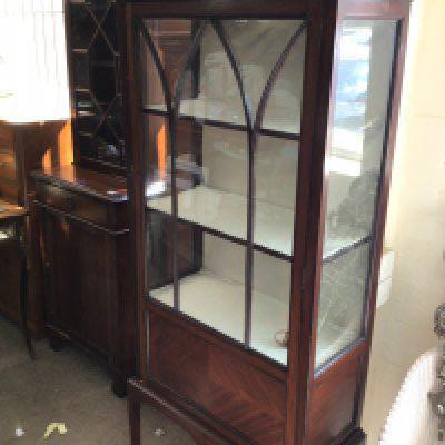 An Edwardian mahogany display cabinet with an arched shaped top above a single door on square legs. NO RESERVE
