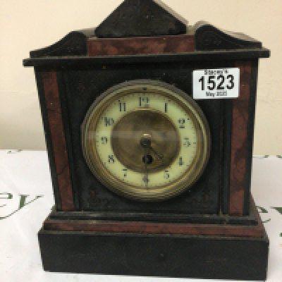 A black slate and marble mantel clock fitted with a French brass movement.height 27cm. NO RESERVE