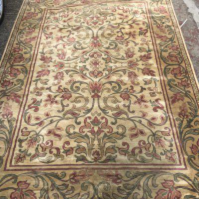 A silk carpet with central foliage pattern repeat pattern boards on a ivory field .6 ft 6 by 9 ft 6 .