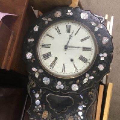 A Victorian wall clock the mother of pearl case inset with a circular dial With Roman numerals.