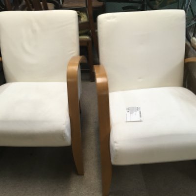A pair of modern design open armchairs.
