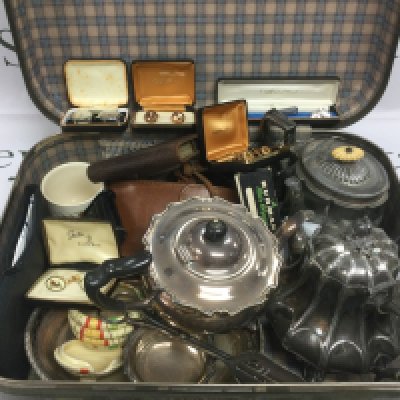 A suitcase of oddments comprising silver plated teapots, cufflinks etc. Shipping category D.