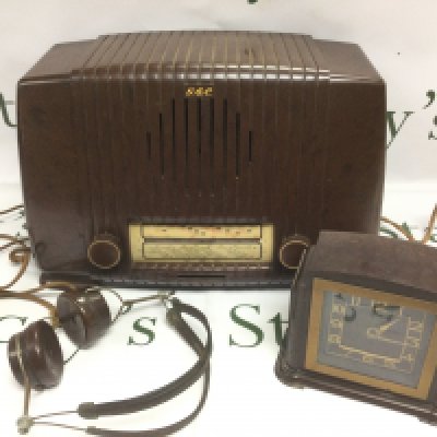 Three bakelite items comprising a radio, clock and headphones. Shipping category D.