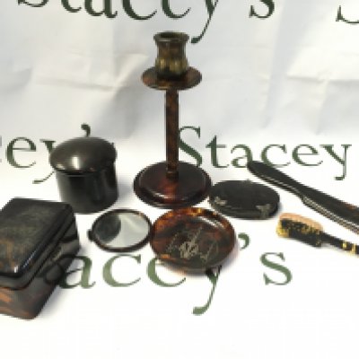 A collection of tortoiseshell items including candlestick , containers , mirror , dish etc. postage cat B