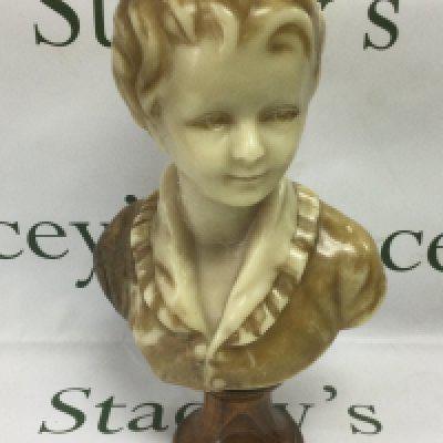 A wax head bust of a child mounted on a plinth, total approx height 39cm. Shipping category D.