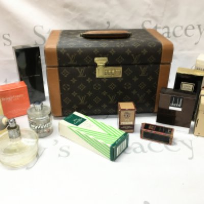 A replica Louie Vuitton case with boxed perfumes including Coco Chanel, Jean Paul, Cartier etc
