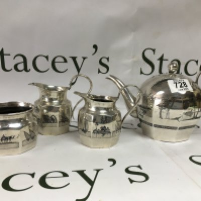 A silver unmarked tea set decorated with Egyptian scenery.