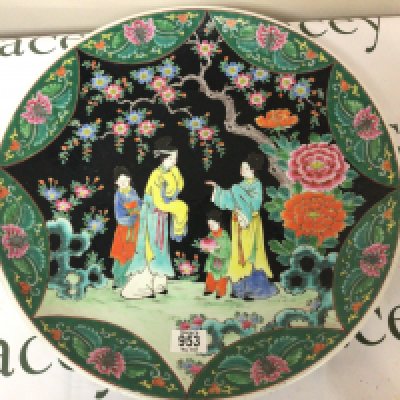 A 20th Century Japanese wall plaque decorated with figures on a black ground amongst flowers and foliage. Diameter 45cm no damage. NO RESERVE