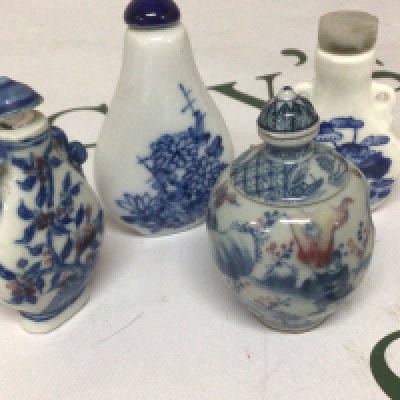 An interesting Chinese porcelain scent bottle with revolving central sections the sides decorated with figures and underglaze iron red with blue Caricature marks to the base and three other blue and white Chinese porcelain scent bottles. (4)