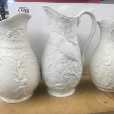 A Collection of eleven Victorian white glazed jugs of classical influences.