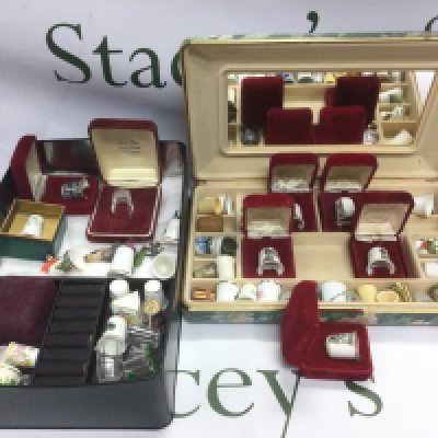 Two boxes of mainly ceramic thimbles. Shipping category B.