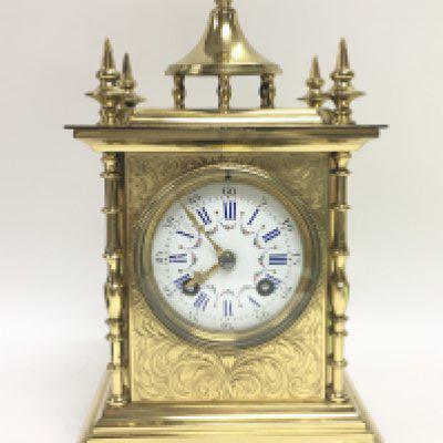 A French brass mantel clock maker S Marti with ornate engraved decoration and a painted porcelain roman numeral dial, with key. Seen working. Dimensions 13x17x28cm. This lot cannot be posted