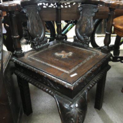 A carved oak corner chair the solid seat on cabriole legs , and one other carved back chair.