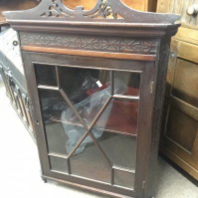 An Edwardian hanging display corner cabinet with blind fretwork and a glazed door. NO RESERVE