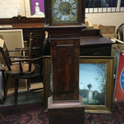 A Mahogany longcase clock of small size Hight 153cm fitted with a silvered chapter ring eight day going with pendulum and two weights.