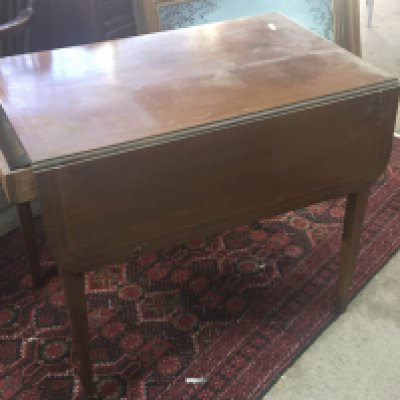A Mahogany Pembroke table the twin flap top with boxwood banding fitted with an oak lined drawer.