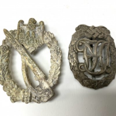 A Germany WWII Sports Badge DRL Silver Class by Wernstein Jena together with a retrospective copy German military badge. (A)