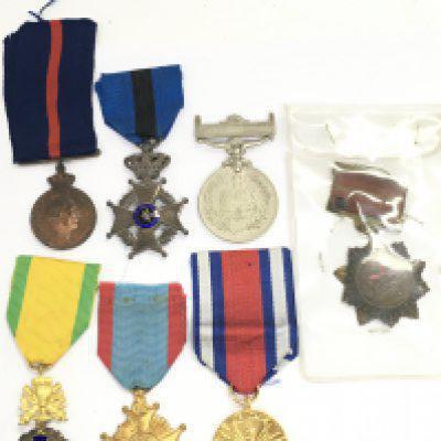 A Collection of military medals including a China 1954 merit, Polish peoples public medal, Belgium Telegraphic Service medal, French military third republic medal, 1956 Islamic Republic of Pakistan commemorative medal, Greek army medal, Belgium Order of Leopold II Medal. Postage category A