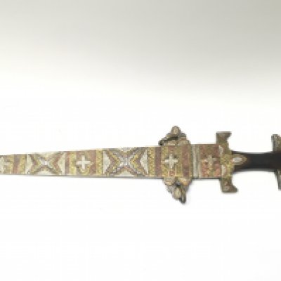 An eastern sword with wooden handle, with brass copper and silvered decoration, 65cm long. This lot cannot be posted