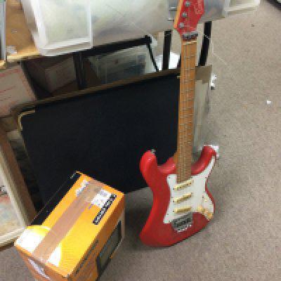 A red encore strat style electric guitar and a boxed Mc Crypt 15 watt practise guitar amplifier. This lot cannot be posted