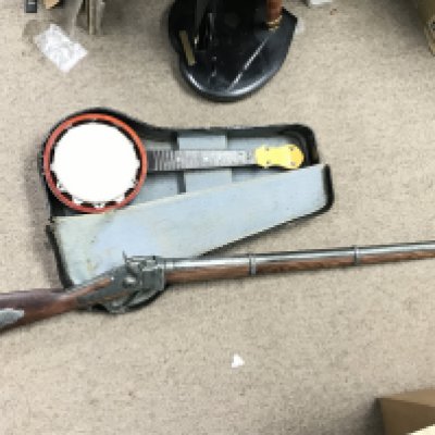A replica American civil war carbine rifle and a cased banjolele.