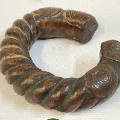 An African Manilla bronze slave currency bracelet, 8cm wide. Postage category A