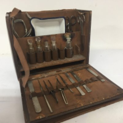 A Vintage leather surgeon case fitted with medical instruments and a Vintage typewriter and a typewriter.