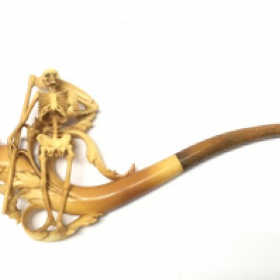A cased skeleton tobacco pipe