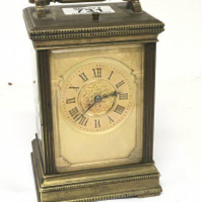 An Edwardian brass cased carriage clock strike repeat with a gilded dial the movement striking on gongs. Seen working strike repeat functions. Height 15cm