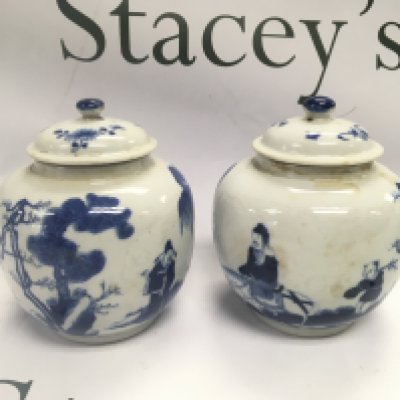A pair of blue and white ginger jars decorated with figures in a landscape setting, four character marks to base, approx height 13cm. Shipping category D.