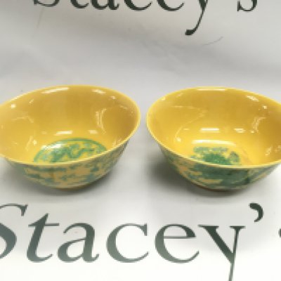 Two yellow glazed Oriental bowls decorated with dragons and six character marks to base, approx diameter 15cm. Shipping category D.