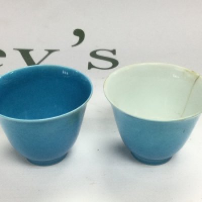 Two rice wine cups in blue, one with a white interior and cracked, approx height 4.5cm. Shipping category D.