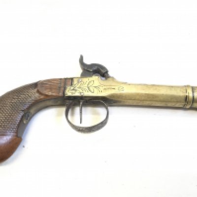 An Early 19th Century brass cannon barrel percussion pistol with a walnut grip steel trigger guard stamped LP to the barrel with light floral pattern engraving.