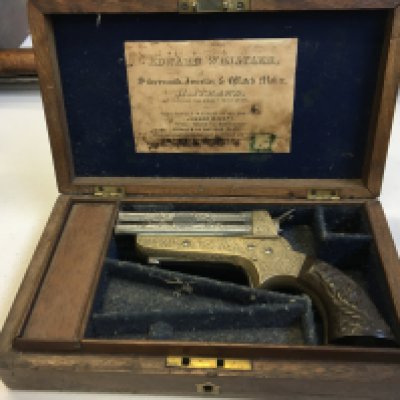 Tipping & Lawden of Birmingham A 19th Century .31 RF Sharp's Patent Four Barrel Repeating Pocket Pistol by Tipping & Lawden. The 3 steel barrels sliding forward for loading, engraved with foliate cartouche panels and with Birmingham proof marks, serial number 600 the silver plate frame richly engraved with scrolling acanthus leaves and flowerheads, with a signed circular panel, sheath trigger, barrel release catch to the underside, the two-piece composition grip scales moulded with acanthus leaves. 6 overall. GWO. Contained in fitted blue felt lined walnut case with brass escutcheon.