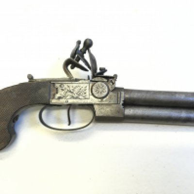 A rare double barrel single trigger late 18th or early 19th century flintlock pistol the steel action engraved no obvious makers marks with a walnut grip action functional but needs refreshing