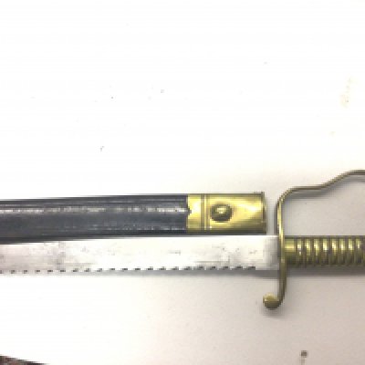 An 1856 British Pioneer sawback bayonet, the blade marked to one side with B 47 with crown above. With leather scabbard brass fittings a good example.