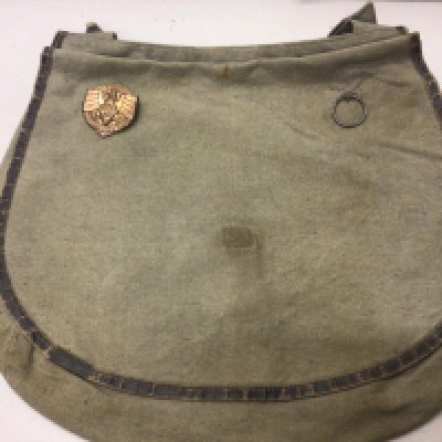A German Third Reich Hitler Youth bag with 1936 Hitler Youth badge attached.