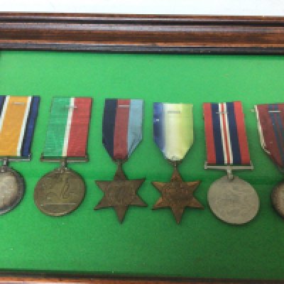 A sealed frame containing six medals 1914-1918 I world war medal a Mercantile medal 1939-45 star Atlantic star 1935-45 Victory medal and an Elizabeth II Coronation medal (6)