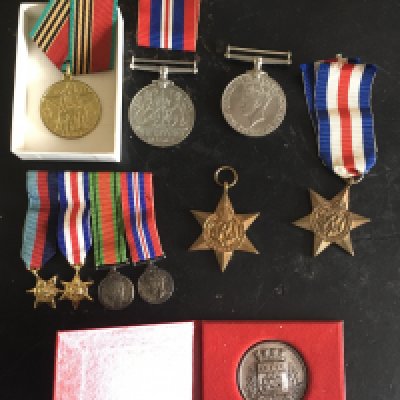 A Group of II World War Medals: Victory Defence France German Star and 39/45 Star with a matching group of miniature dress medals a commemorative Nantes medal. Instructions to sell.