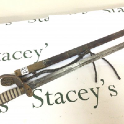 A British Officer Navy Sword RNR the sword the maker Fenton Bro Sheffield with wired shagreen grip brass fittings the blade with engraving including Royal cypher for George V. Leather and brass scabbard.