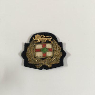 A collection of uniform badges consisting of a large size officers badge from the British petroleum company London, officers badge from the British petroleum company London, officers badge from the Cunard line shipping company, officers badge from the royal fleet auxiliary unit circa 1950s, officers badge from the Royal Mail line and an orient line as used in service stewards badge