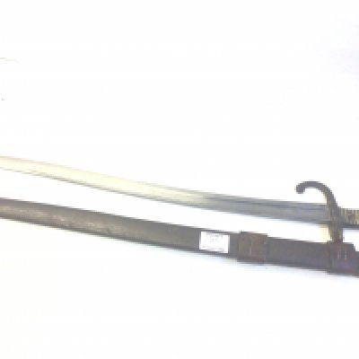 A French 19th century Chasspot bayonet with an engraved steel blade edge and brass grip with steel scabbard. With attached leather frog.