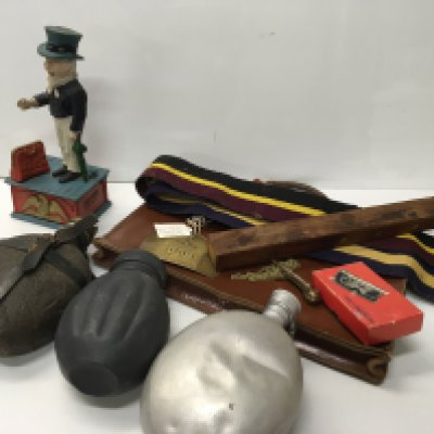 A collection of oddments comprising Royal Corps of Signals plaque and belt water flasks a reproduction cast iron painted money box and other oddments.
