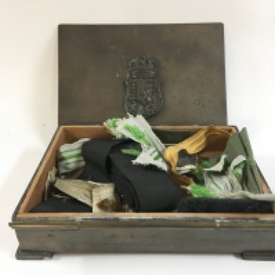 A German box with various cloth badges inside. Postage category B